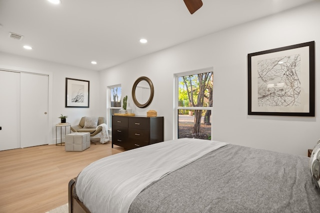 bedroom with ceiling fan and light hardwood / wood-style floors