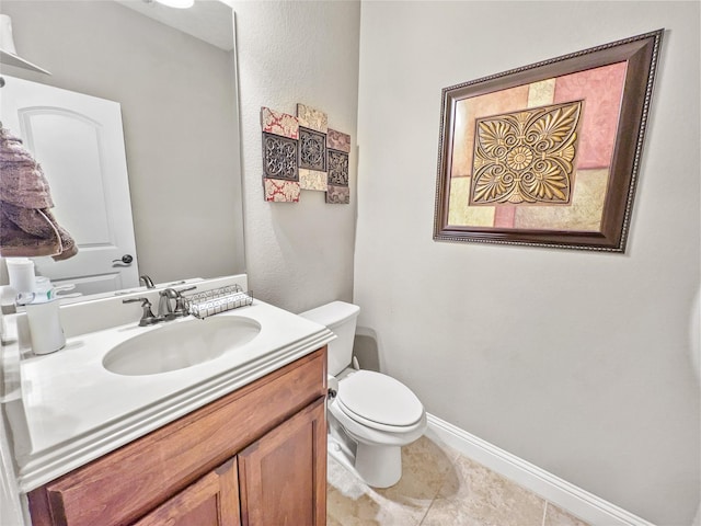 bathroom featuring tile patterned floors, vanity, and toilet