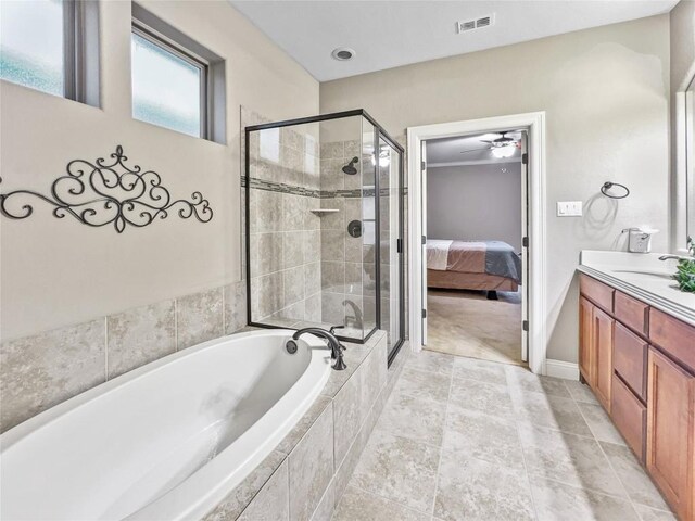 bathroom featuring vanity and shower with separate bathtub