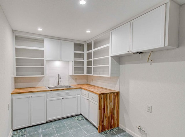 110 W Saint Johns Ave, Austin, TX 78752 - kitchen featuring backsplash, open shelves, wood counters, and a sink