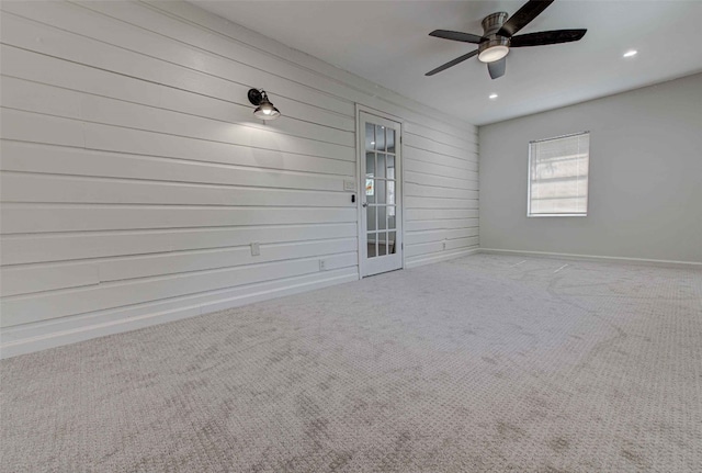 empty room with light carpet and ceiling fan