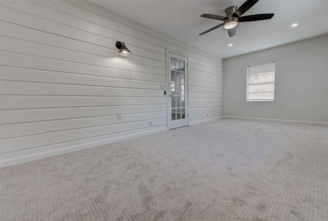 110 W Saint Johns Ave, Austin, TX 78752 - empty room with baseboards, wooden walls, recessed lighting, a ceiling fan, and carpet