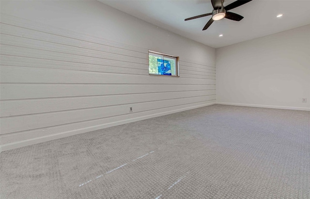 carpeted spare room with ceiling fan