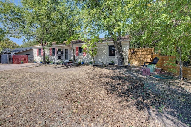 110 W Saint Johns Ave, Austin, TX 78752 - view of front of house featuring fence and brick siding