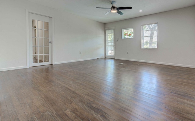 spare room with ceiling fan and dark hardwood / wood-style flooring