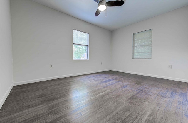 empty room featuring ceiling fan and dark hardwood / wood-style flooring