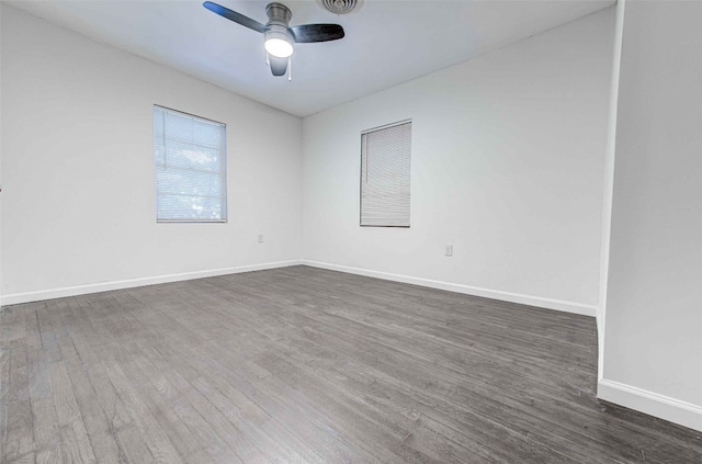 empty room with ceiling fan and dark wood-type flooring