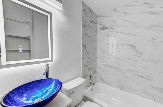 full bathroom with vanity, toilet, and tiled shower / bath combo