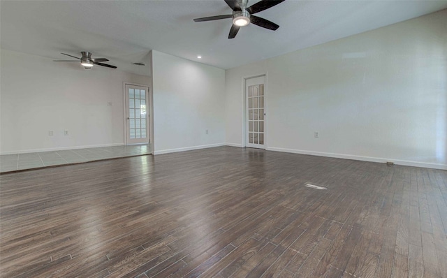 unfurnished room featuring ceiling fan and dark wood-type flooring