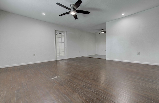 empty room with dark hardwood / wood-style flooring and ceiling fan