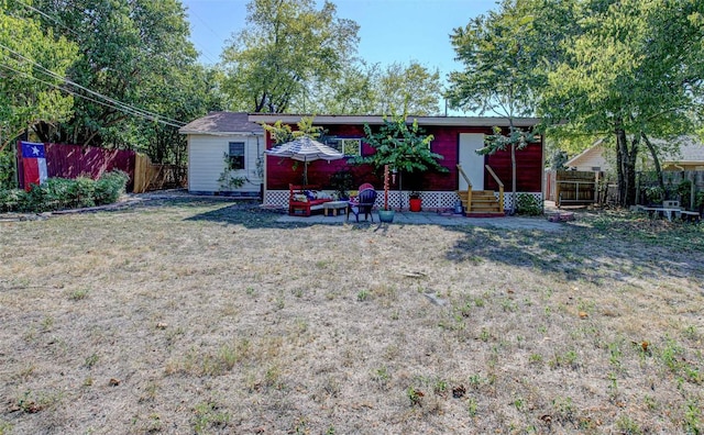 110 W Saint Johns Ave, Austin, TX 78752 - back of property with a lawn, fence, and entry steps