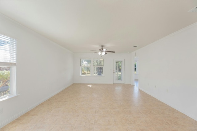 tiled empty room featuring ceiling fan and crown molding