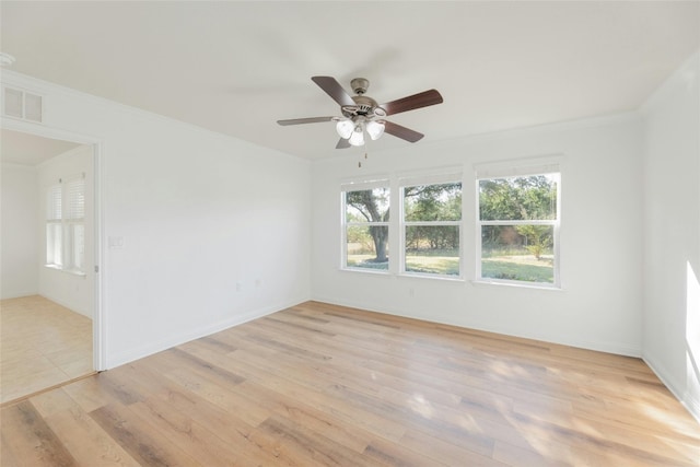 unfurnished room featuring ceiling fan, light wood-type flooring, and ornamental molding