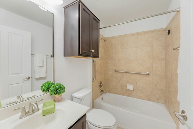 full bathroom featuring toilet, vanity, and tiled shower / bath