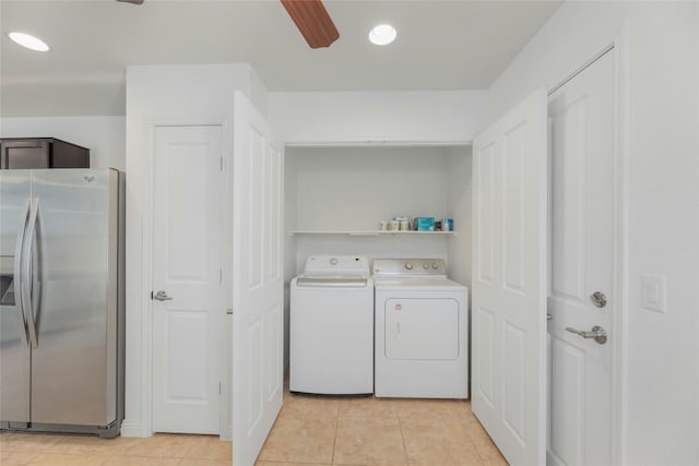 clothes washing area featuring ceiling fan, washer and clothes dryer, and light tile patterned flooring