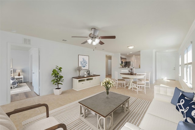 living room featuring ceiling fan and light tile patterned floors