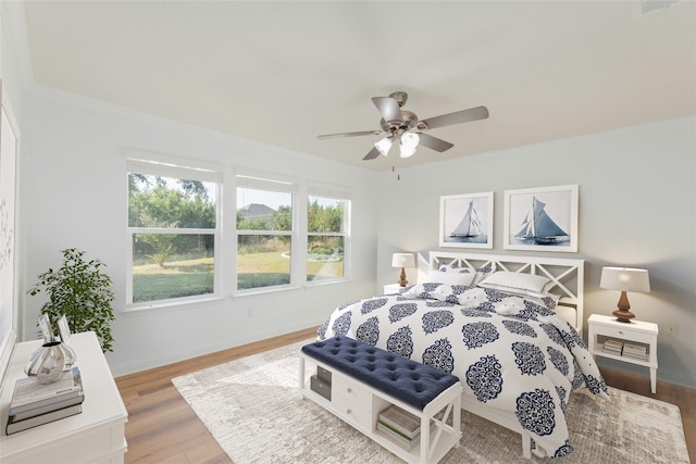 bedroom with hardwood / wood-style floors and ceiling fan