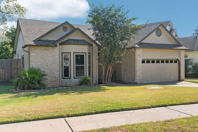 view of front of property with a garage and a front yard