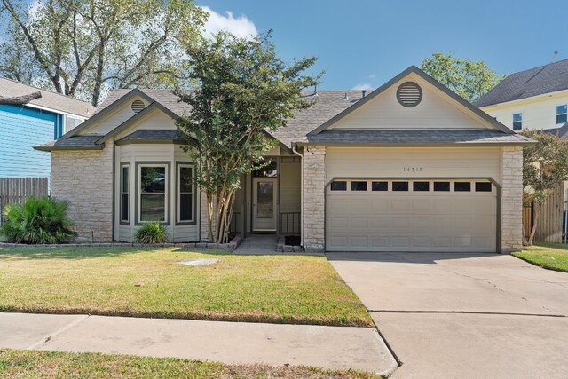 view of front of home with a front yard and a garage