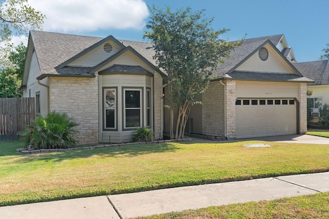 view of front facade featuring stone siding, a shingled roof, a front lawn, and fence