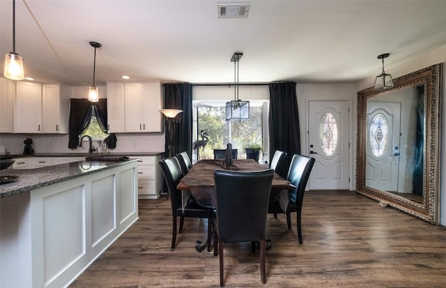12614 Crystal Creek Dr, Buda, TX 78610 - dining area with healthy amount of natural light and dark wood-type flooring