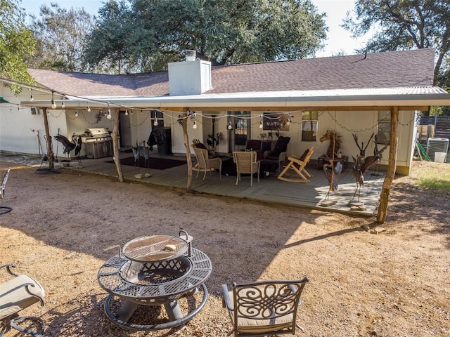 12614 Crystal Creek Dr, Buda, TX 78610 - back of property featuring a wooden deck, a chimney, and roof with shingles