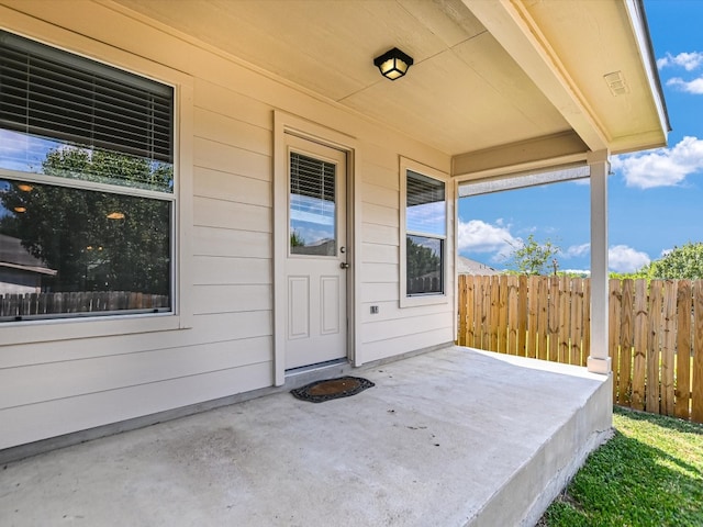 property entrance featuring a patio area