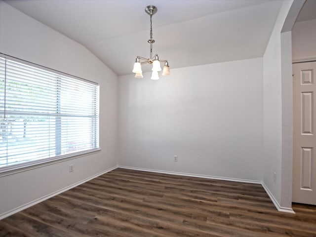 unfurnished room with vaulted ceiling, a notable chandelier, and dark wood-type flooring