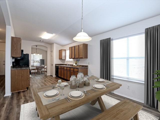 dining area featuring dark hardwood / wood-style floors, a notable chandelier, and sink