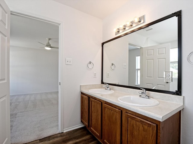 bathroom featuring ceiling fan, vanity, and wood-type flooring