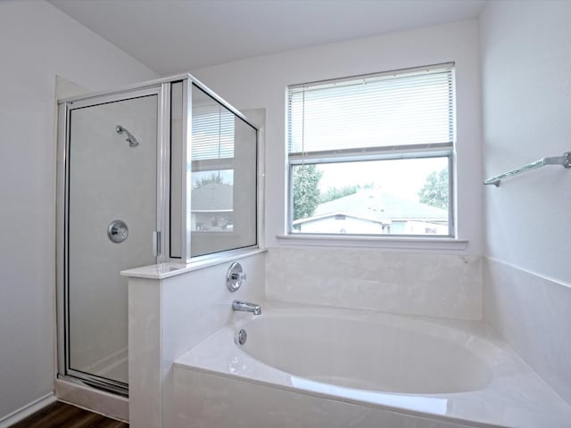 bathroom featuring wood-type flooring and plus walk in shower