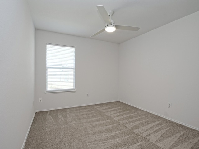 empty room featuring light carpet and ceiling fan