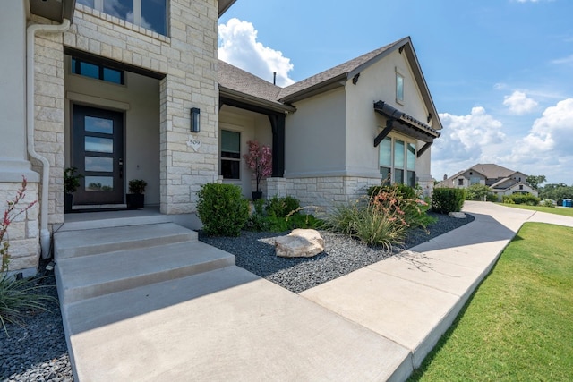 entrance to property featuring a yard