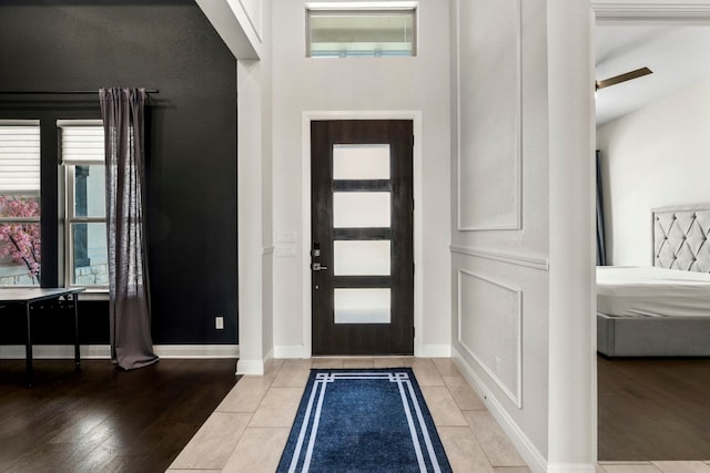 foyer entrance featuring beamed ceiling and wood-type flooring