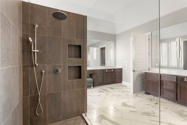 bathroom featuring vanity and tiled shower