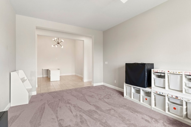 interior space featuring light colored carpet and a chandelier