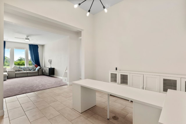 unfurnished office featuring light colored carpet and ceiling fan