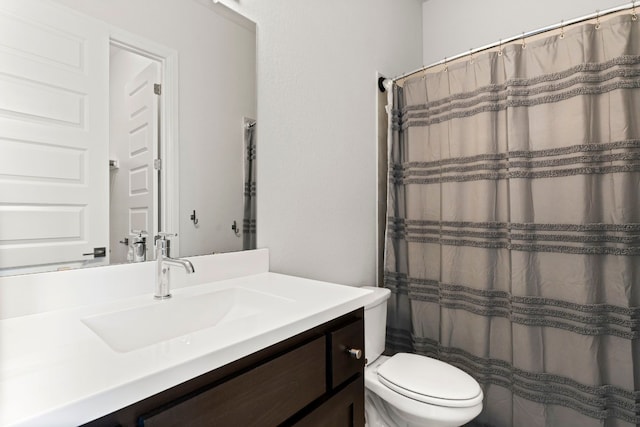 bathroom featuring toilet, a shower with curtain, and vanity