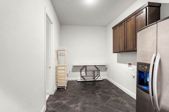 clothes washing area with gas dryer hookup and cabinets