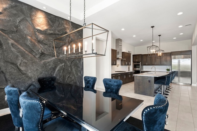 dining space featuring sink and light tile patterned floors