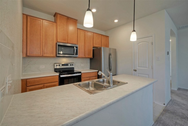 kitchen with backsplash, sink, hanging light fixtures, and appliances with stainless steel finishes