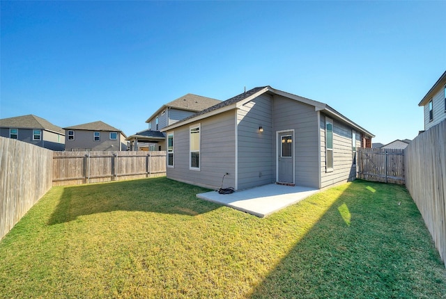 back of property featuring a lawn and a patio area