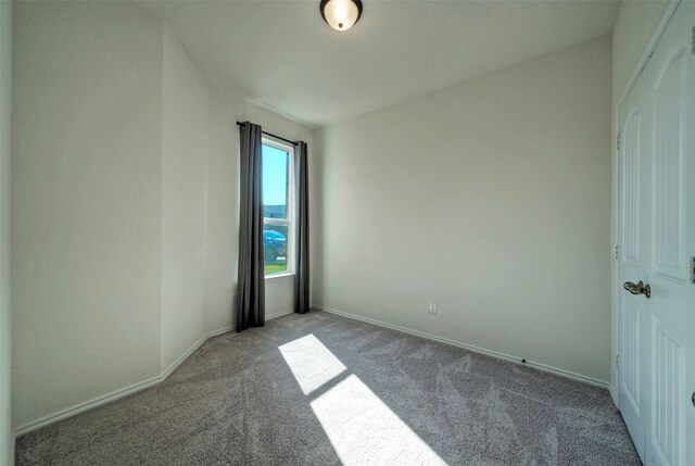 unfurnished room with light colored carpet