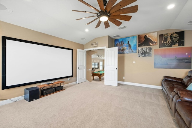 cinema with light carpet, vaulted ceiling, and ceiling fan