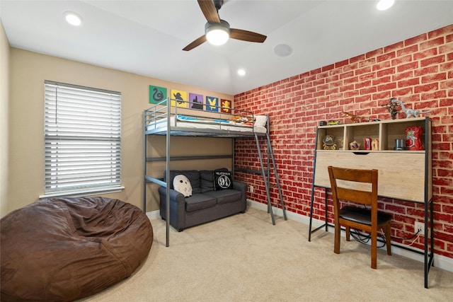 carpeted bedroom featuring ceiling fan and brick wall