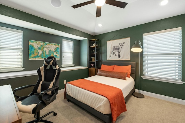 bedroom featuring multiple windows and ceiling fan