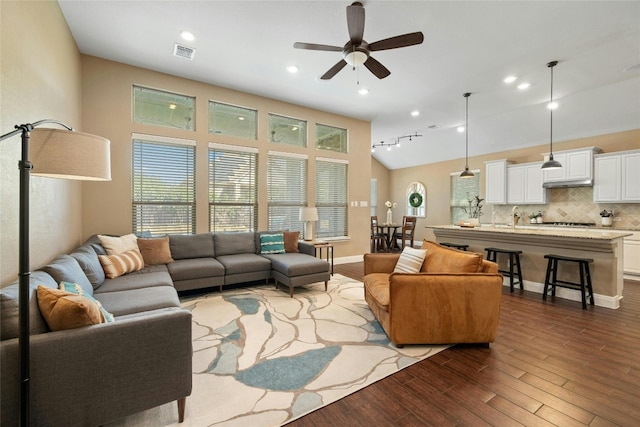 living room with hardwood / wood-style flooring, ceiling fan, lofted ceiling, and sink