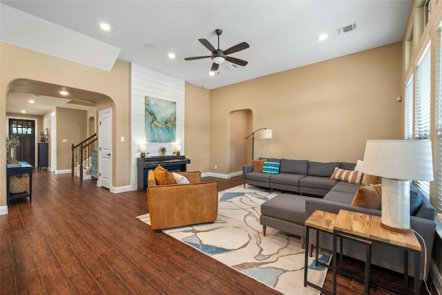 living room featuring wood-type flooring and ceiling fan