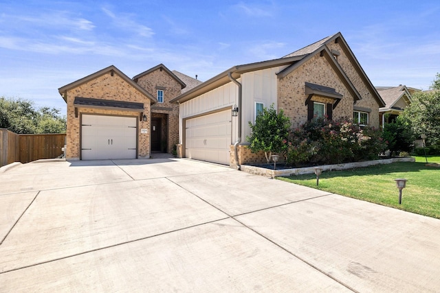 view of front of property with a front yard and a garage