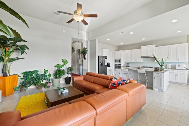 tiled living room featuring ceiling fan